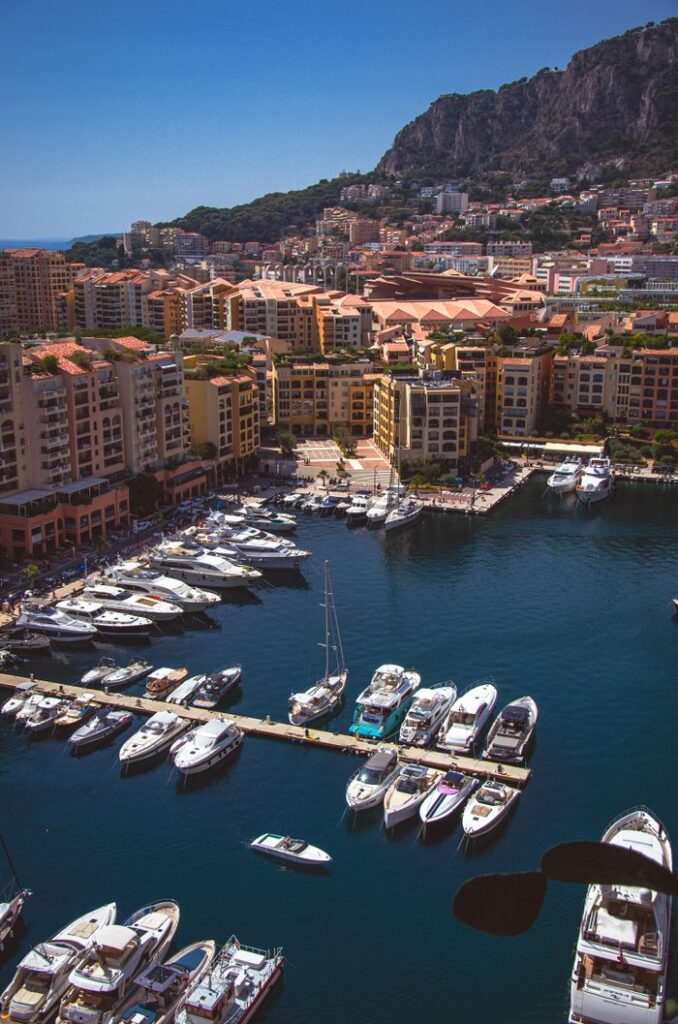 A stunning view of the yacht-filled marina in Monaco-Ville, framed by hills and urban architecture.