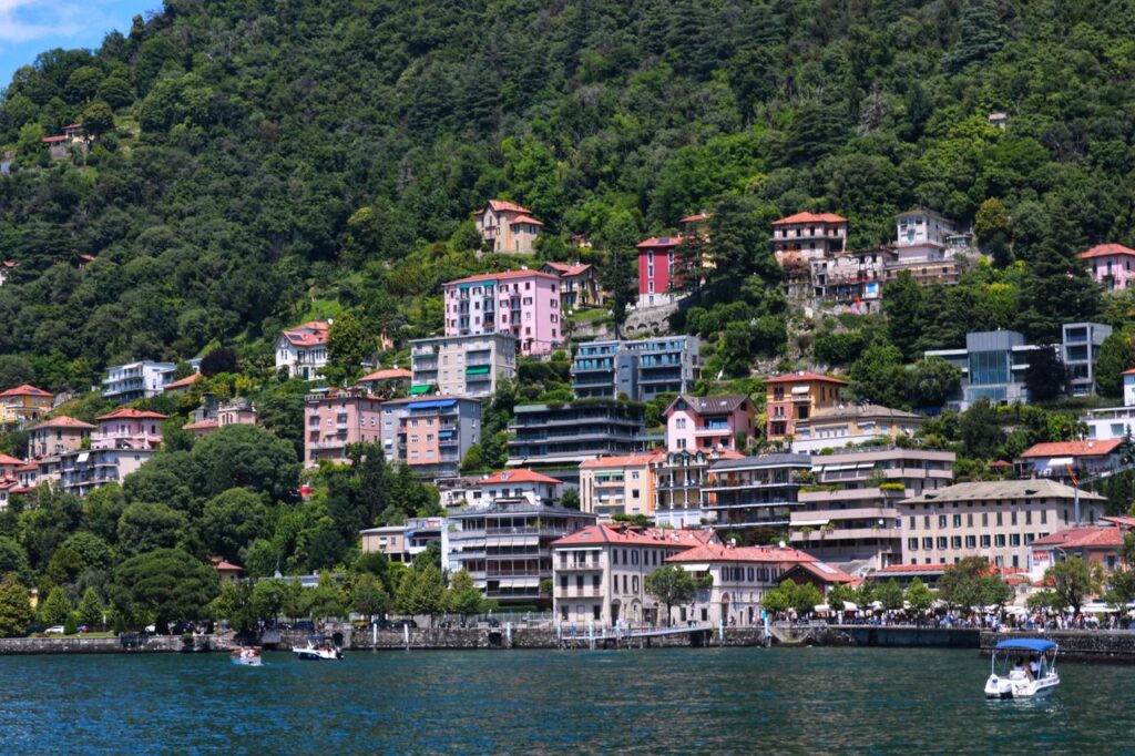 Scenic view of colorful hillside homes by Lake Como, showcasing Italian architecture.
