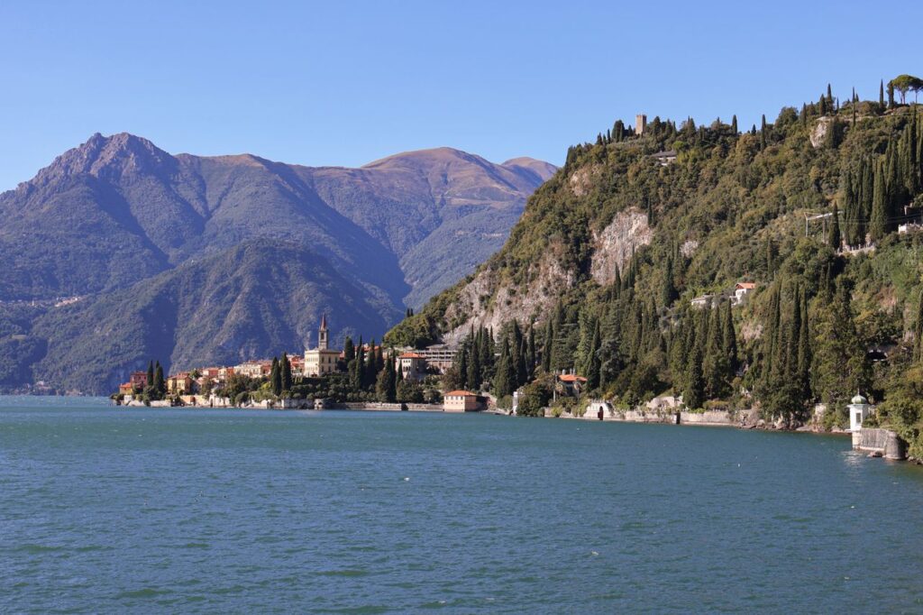 Scenic view of Lake Como with its calm waters and surrounding mountains in Varenna, Italy.