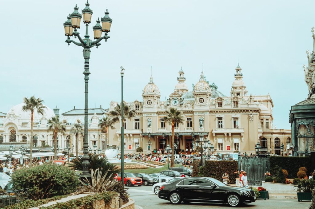 Casino de Monte Carlo with luxury cars and visitors in Monaco