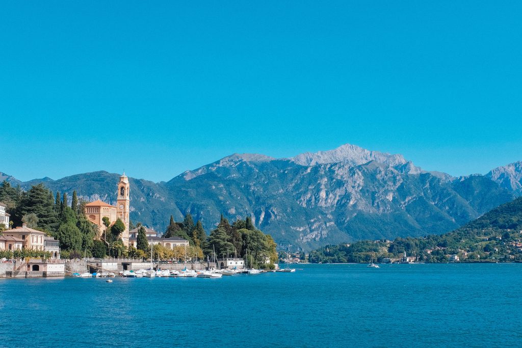 Lake Como shoreline with mountains and historic lakeside architecture in Italy